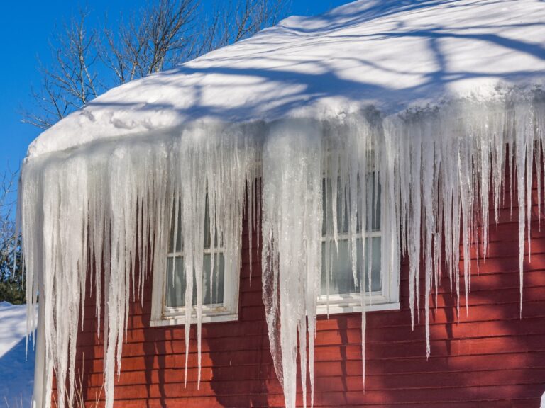 The house is surrounded by an ice dam. This could cause some property damage.
