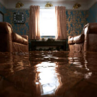 Flooded living room with water covering the floor.