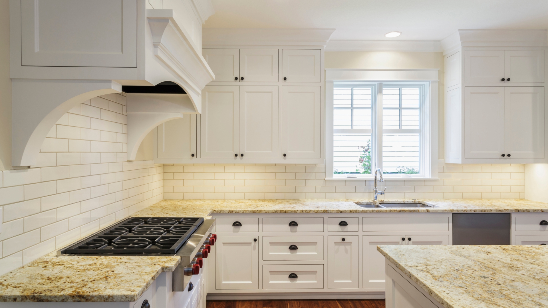 Picture of a kitchen with stylish white cabinets.