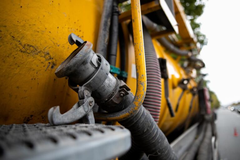 What happens if I smell sewage? Call the plumbers or damage restoration experts immediately. A sewage removal truck on a worksite.