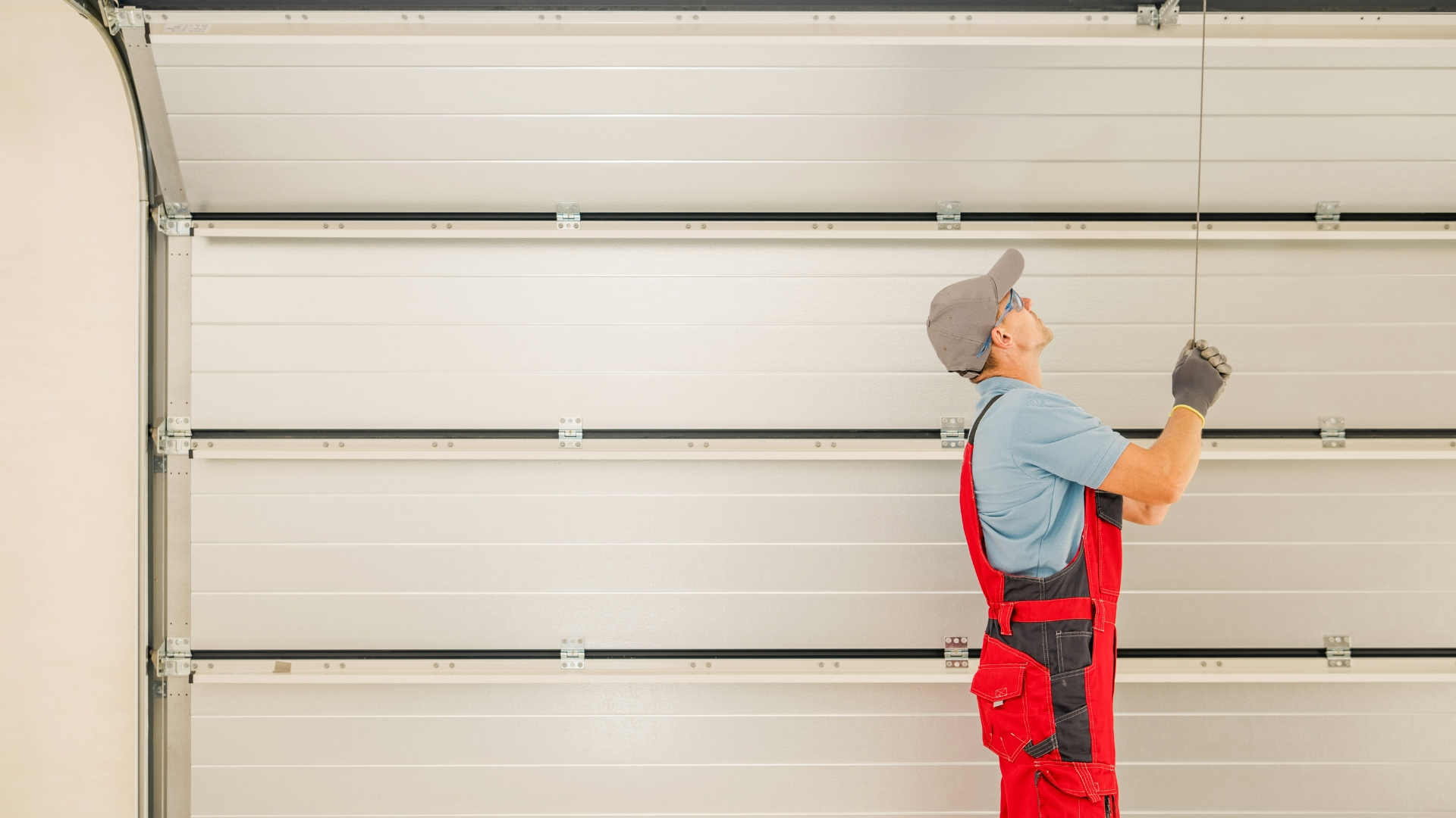 A handyman doing a new garage door installation.