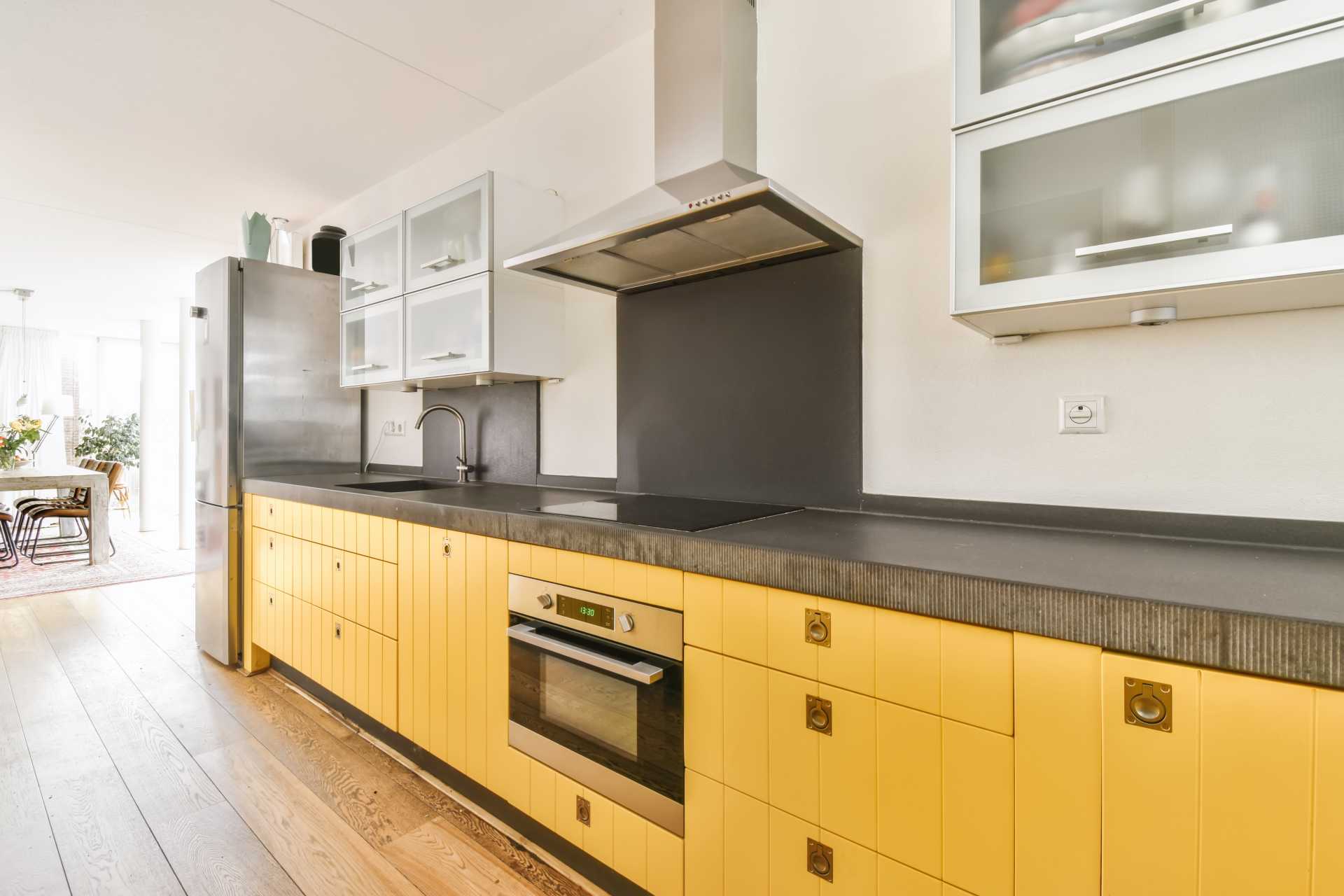 Kitchen with yellow durable cabinets.